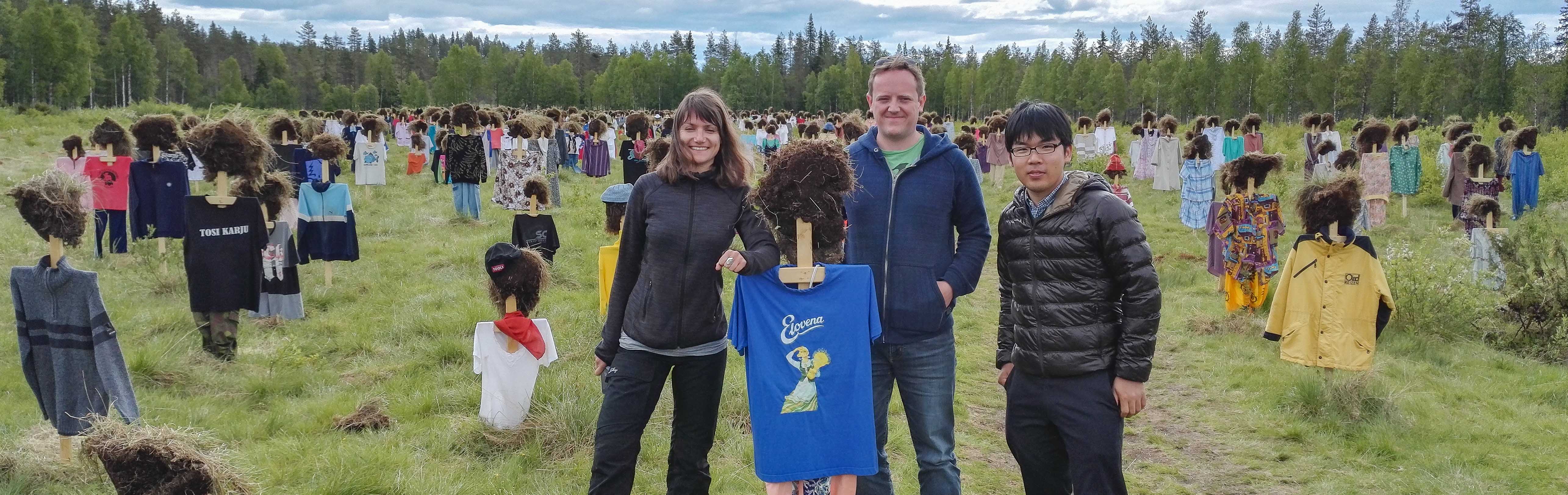 Saskia Wutke, Craig Michell, and Ryosuke Nakadai visiting the world-famous Hiljainen kansa (The silent people) installation in Suomussalmi in 2018